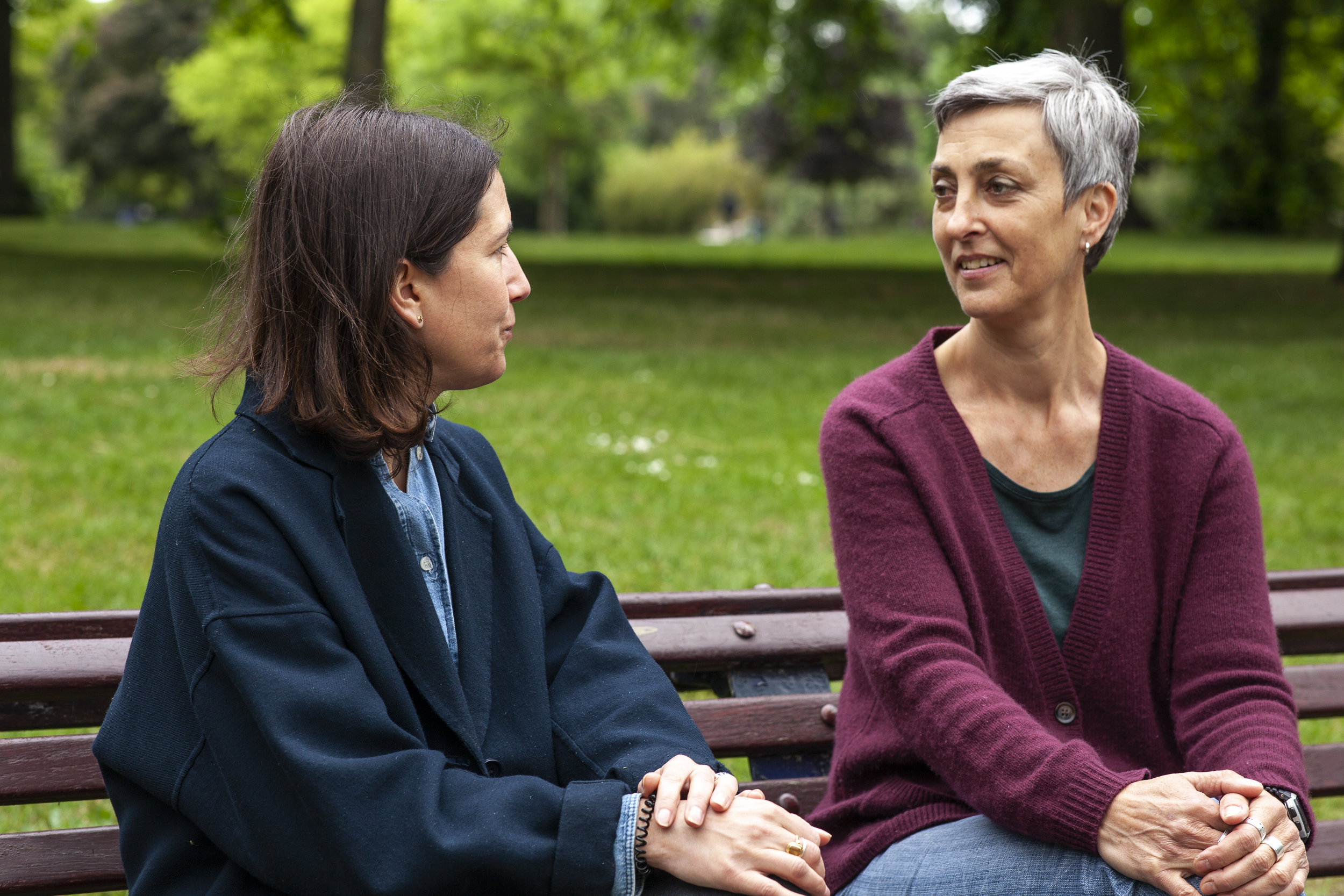 Karen Liebenguth sitting on a bench with a life coaching client, in Victoria Park, East London