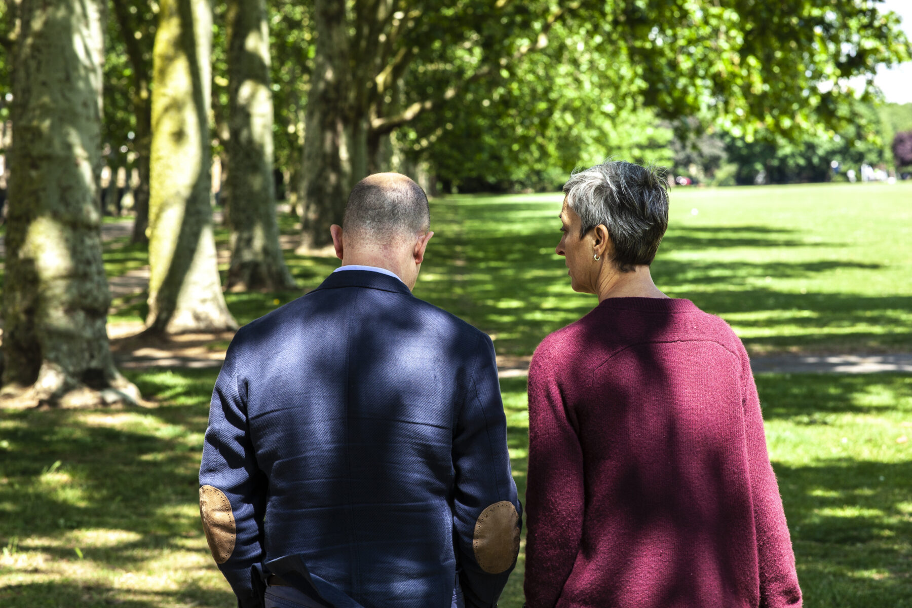 Karen Liebenguth walking with an executive coaching client, though the green trees of Victoria Park, East London